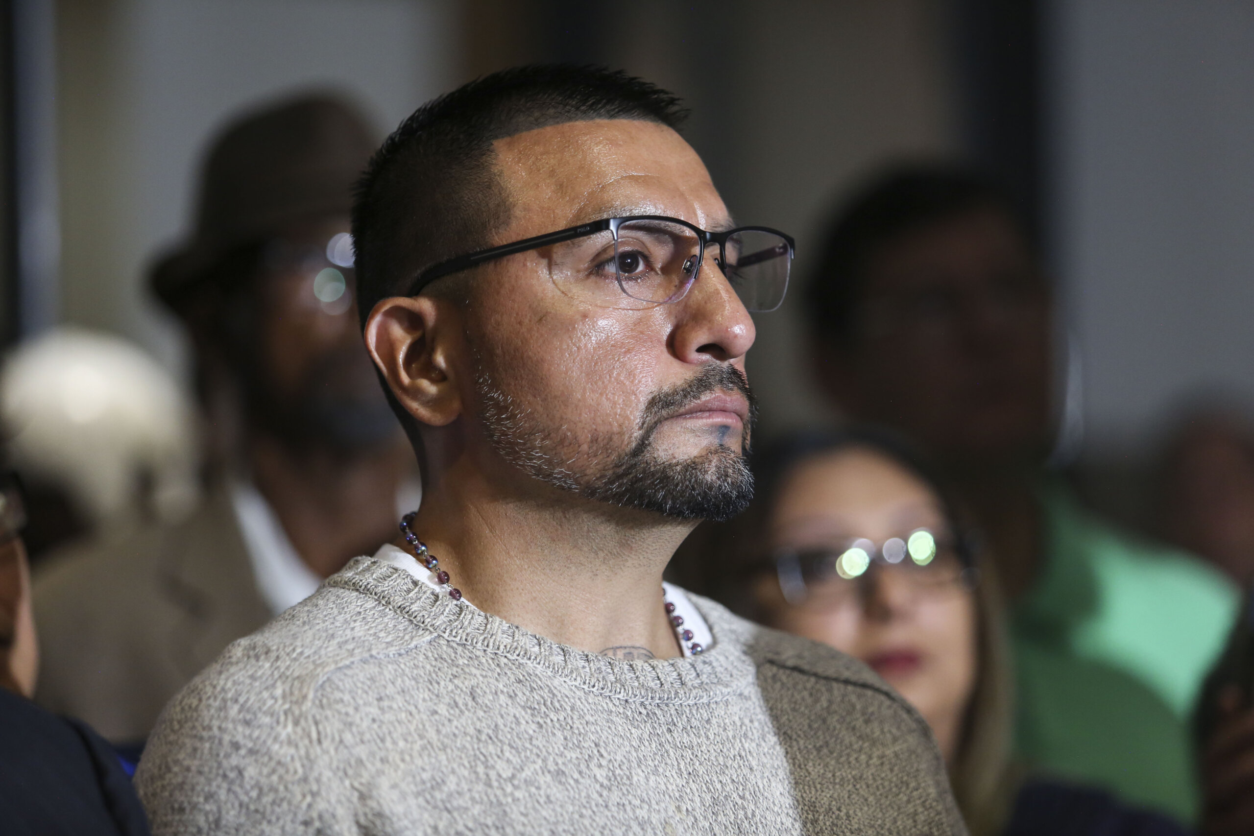 Martin Santillan listens to Paul Casteleiro of Centurion Ministries after the exoneration hearing of the 1997 capital murder of Damond Wittman on Wednesday, March 22, 2023, at Frank Crowley Courts Building.
